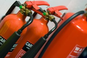 Three fire extinguishers arranged in a row